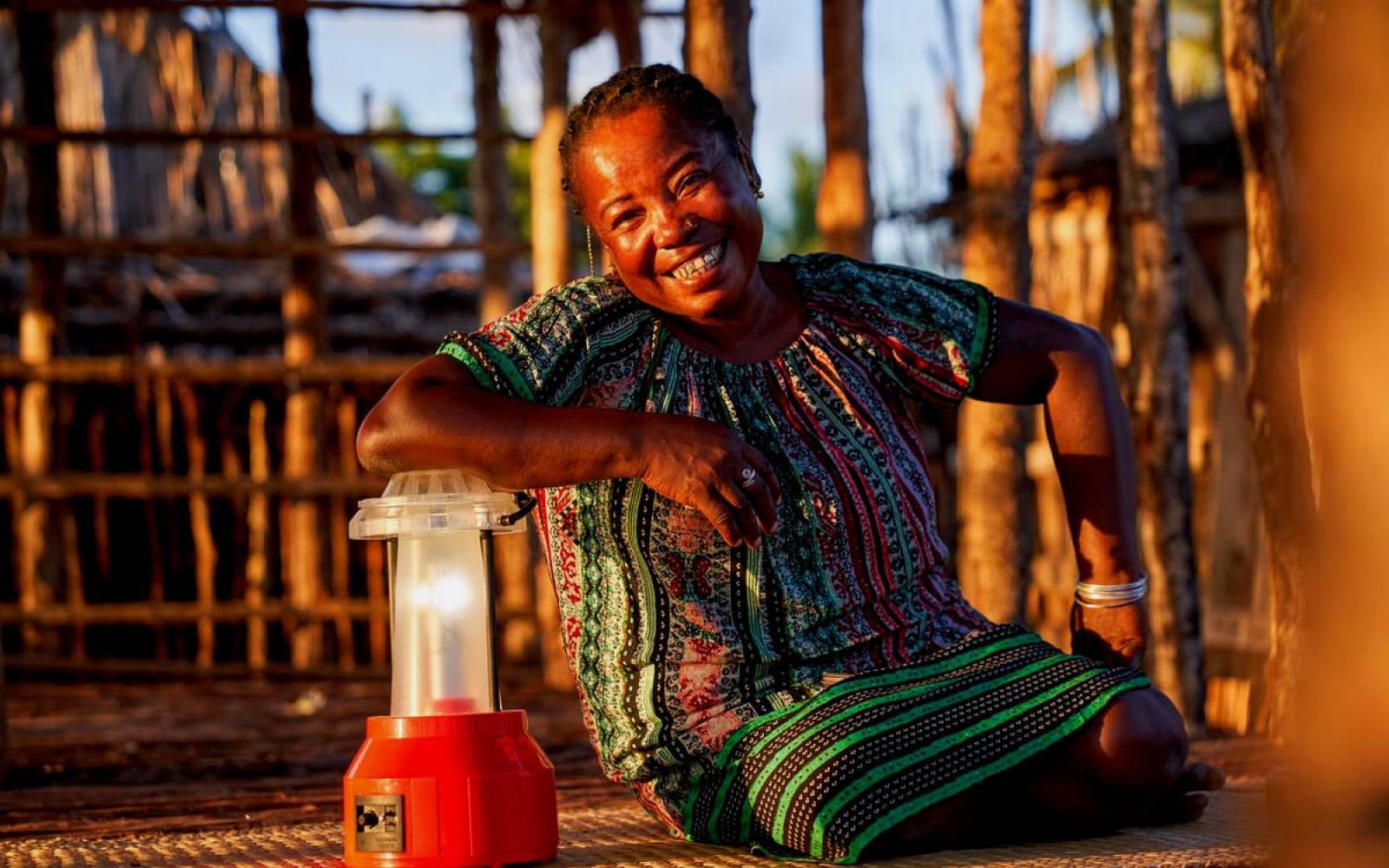 solar technician Kingaline sits next to a solar lamp, Barefoot College Madagascar